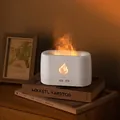 White flame aroma diffuser and humidifier with warm light on decorative book stack - White Warm Light