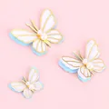 3D butterfly cake toppers with pearls and gold edges on light pink background - Pearl Blue Butterfly