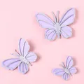 Three lavender and silver glitter butterfly cake toppers on a pink background - Silver Purple Butterfly