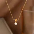 Elegant gold titanium necklace featuring a knot design and polished pearl pendant - 19【h1041】knotted Pearl Necklace Gold