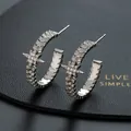 Close-up of C-shaped star earrings with pavé zircons on black leather display - Silver Star C-shaped Hoop Style(G)