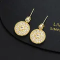 Macro shot of gold starburst drop earrings featuring micro-pave white cubic zirconia - Golden Sunburst Star Round Dangle Style(H)