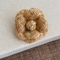 Close-up of pink tweed camellia flower brooch with gold metallic threads and petal texture - Khaki