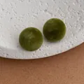 Detail shot of vintage dark green flocked round stud earrings with matte velvet texture - Green