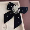 Elegant velvet bow brooch with pearl flower and rhinestone accents on a display tray - Black Bow Brooch S-189