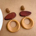 Close-up of bohemian resin and wood drop earrings featuring hollow round geometric design - Khaki (D-112)