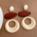 Detailed view of vintage resin and wood teardrop earrings on a brown textured background - Cream White (D-112)