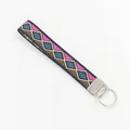 Detail of ethnic geometric diamond embroidery on woven wristlet strap with metal ring - Geometric Style 01