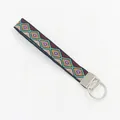 Detailed close-up of ethnic geometric embroidered wristlet strap with silver metal keyring - Geometric Style 03