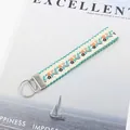 Gros plan sur le cordon de poignet jacquard ethnique de 25 mm avec fermoir argenté - Feuille Verte Fleur Jaune Beige (09-06D)