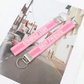 Detail of pink embroidered Best Friends wrist strap keychains with silver metal clasps - Best Friends-04