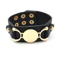 Wide black PU leather cuff bracelet featuring a large polished gold metal disk accent - Black