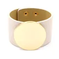 Wide beige PU leather cuff bracelet featuring a large polished gold metal round disk - Off White