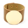 Street style wide tan leather cuff bracelet featuring a large polished gold metal disk - Khaki