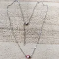 Macro shot of silver-plated evil eye necklace with lobster clasp and adjustable chain - Red Eye Steel