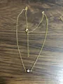 Detail of gold evil eye necklace with lobster clasp and adjustable extension chain - Black Eye Gold