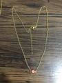 Detailed close-up of gold stainless steel necklace with red enamel evil eye pendant - Red Eye Gold