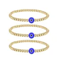 Detailed view of three gold beaded bracelets featuring blue evil eye charms and metal beads - Triple Layer Style / Silver