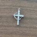 Macro view of brass cross pendant with 3A cubic zirconia in 18K gold plating on wood - Crown Cross Silver