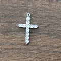 Detailed view of silver cross pendant with micro-pave zircons on a wooden background - Cross Accessory Silver