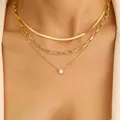 Detailed view of layered 18K gold-plated necklace with snake chain and crystal pendant - Snake Bone Paperclip Zirconia Triple Necklace / Gold