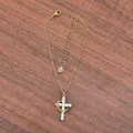 Detail of 18K gold double-layer necklace with crystal cross pendant on wood surface - Single Layer Gold With Pendant