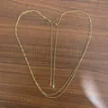 18K gold-plated double-layer stainless steel body chain in a heart shape on wood - Gold