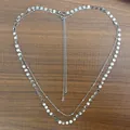 Silver double layer waist chain with round metal sequins on a wooden background - Steel