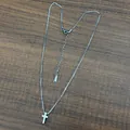 Detailed view of silver stainless steel box chain with a mini cross pendant on wood - Silver with Box Chain