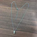 Detailed macro view of a silver stainless steel cross pendant necklace with adjustable chain - Silver with Cable Chain