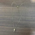 Detailed view of gold stainless steel cross pendant with lobster clasp and O-chain - Gold with Cable Chain