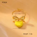 Detail view of gold bow heart ring with 2.1cm diameter and 1.9cm pendant size measurements - Bright Yellow Style
