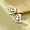 Macro shot of silver heart studs with size dimensions 2.5cm by 2.45cm and weight 10g - NMSE-C652-1 Heart Steel