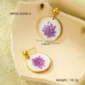 Detailed view of round gold stainless steel earrings with purple dried flowers inside - Round Purple Dried Flower Earrings (NMSE-G558-2)
