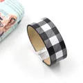 Detailed shot of black and white checkerboard PU leather wide bracelet with magnetic clasp - Black and White Plaid