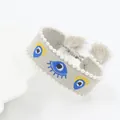 Detailed embroidery of evil eye charms and white pearl trim on bohemian braided bracelet - Light Gray