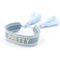 Detailed view of light blue woven friendship bracelet with PRETTY embroidery and tassels - Light Blue PRETTY
