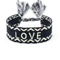 Bracciale intrecciato stile etnico nero con ricamo LOVE bianco e nappe - Sfondo Nero LOVE