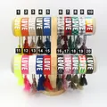 Set of 20 braided LOVE embroidery friendship bracelets with tassels on a display stand - Style 1