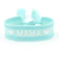 Close-up of woven friendship bracelet featuring white MAMA embroidery and tassel detail - MAMA-5
