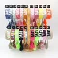 Detailed display of 21 colorful embroidered LOVE bracelets with tassels on a wooden stand - 30#