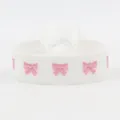 Adjustable woven bracelet featuring white embroidery band and three pink bow patterns - Bow Embroidery / White