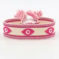 Handgeweven Evil Eye armband met roze kwastjes en bohemian borduurwerk details - Donkerroze