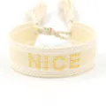 Minimalist woven friendship bracelet in cream color featuring a gold beaded NICE patch - Gold NICE Style
