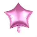 Detailed macro view of a star-shaped matte pink foil balloon showing the inflation valve - Pink