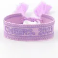Purple woven friendship bracelet with Cheers 2023 embroidery and tassel closure - 2023-3