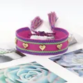 Detail of hand-woven magenta friendship bracelet with golden heart studs and tassels - Gold Heart Rivets / Magenta (H-G-006)