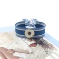 Detalle de pulsera Noosa tejida en azul y blanco con botón de presión y borlas largas - Azul Blanco (21#)