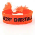 Macro detail of orange embroidered Merry Christmas woven friendship bracelet with tassels - Orange MERRY CHRISTMAS