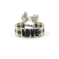 Close-up of woven friendship bracelet with LOVE embroidery and tassel detail - Style 47 Navy Daisy